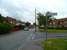 All adopted road street signs across Hillingdon pay regard to the normal, common consensus definition of each London district, much of which is based on the old and revised parishes and more particularly the secular Urban Districts and early ward electoral divisions which succeeded them in government. Looking west at the junction of Hesa and Wesley Roads (geograph 3651135).jpg