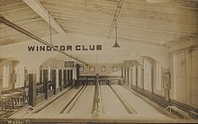 A bowling alley in Windsor, Vermont, United States, in about 1910. Tenpins and duckpins are stored on a shelf behind the pit areas, suggesting that the same bowling lanes were used by the different variations of the sport. PostcardWindsorVTWindsorClubBowlingLanesCirca1910.jpg