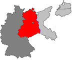 Division of Germany after World War II - Dark grey became (West) Germany, red became the DDR with the dark grey in the middle being West Berlin, the crescent-shaped light grey area and the lower of the other two light grey areas were given to Poland and the upper light-grey area became Russia's Kaliningrad