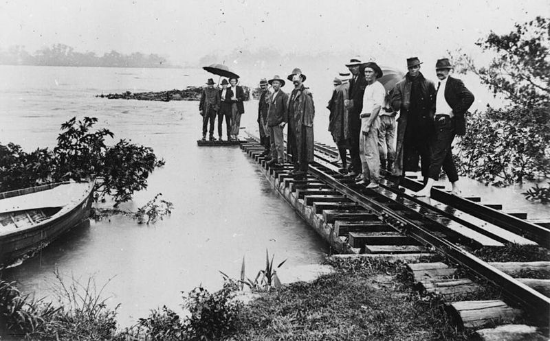 File:StateLibQld 1 84640 Group of men standing on the flooded railway bridge over the Burdekin River, 1917.jpg