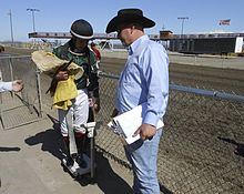 Jockey being weighed post-race, holding equipment Sun Downs Kennewick 02.JPG