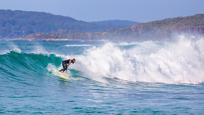 A surfer catches a ride at Pretty Beach, NSW, Australia