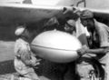 Mechanics installing "babies" (fuel supply) on P-51 "Mustang".