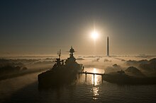 Texas seen at sunrise at the end of 2007; the obelisk in the background is the San Jacinto Monument USS TexasSan Jacinto Park in Fog.jpg