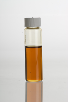 Vetiver (Vetiveria zizanioides= Chrysopogon zizanioides) essential oil in a clear glass vial VetiverEssentialOil.png