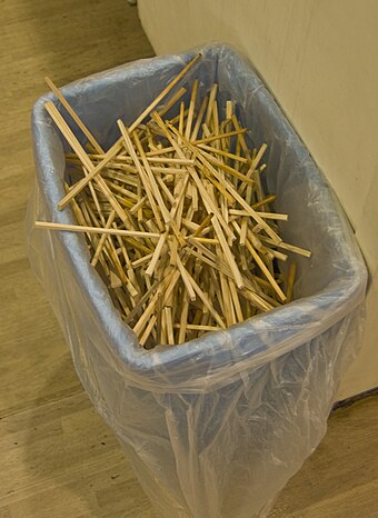 Disposable chopsticks in a university cafeteria trash bin in Japan.
