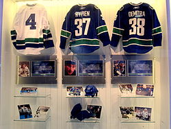 Following Rypien's death, the Canucks produced a display in the Rogers Arena concourse featuring his jersey, equipment and photos. (Also honoured in the display are Barry Wilkins (left) and Pavol Demitra (right), both of whom also died in the summer of 2011.)