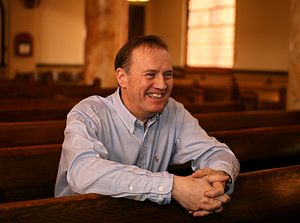 Man sitting on a wooden pulpit in a church