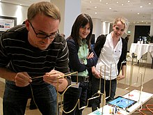A man playing a version of the wire loop game. Wire Loop Game.jpg