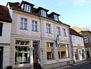 Two residential buildings with a “city café” and ancillary buildings