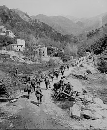 Men of the 370th Infantry Regiment marching through Prato, Italy April 9, 1945. Ww2 allied advance prato italy.jpg