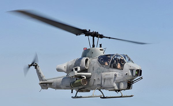 A Bell AH-1 SuperCobra with a semirigid rotor system with a 2-bladed main rotor