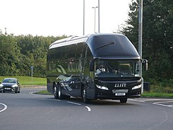 Acklams Coaches' E14 ACK, a 2010 Neoplan Starliner and formerly the Vote Leave campaign's "Brexit Bus", rounds the Mount Pleasant North Roundabout in Kingston upon Hull now back in the black and silver livery of Acklams Coaches' 'Elite Travel' arm