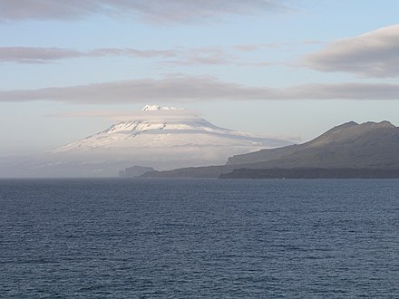 The snow-covered Beerenberg volcano beyond the coastal hills