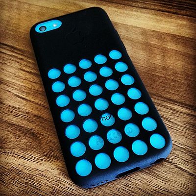 A blue iPhone 5C in the Apple-produced black case.
