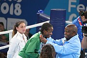 Deutsch: Boxen bei den Olympischen Jugendspielen 2018 Tag 12, 18. Oktober 2018 - Medaillenzeremonie im Fliegengewicht der Mädchen - Gold: Martina La Piana (Italien), Silber: Adijat Gbadamosi (Nigeria), Bronze: Heaven Destiny Garcia (USA); Medaillenübergabe durch Habu Gumel (IOC, Nigeria), Geschenkübergabe durch Dr. Joseph O. Ayeni (Nigeria, AIBA). English: Boxing at the 2018 Summer Youth Olympics on 18 October 2018 – Girl's flyweight Medal Ceremony - Gold: Martina La Piana (Italy), Silver: Adijat Gbadamosi (Nigeria), Bronze: Heaven Destiny Garcia (USA); Medal handover by Habu Gumel (IOC, Nigeria), Gift presented by Dr. Joseph O. Ayeni (Nigeria, AIBA). Español: Boxeo en los Juegos Olímpicos Juveniles de Verano de 2018 en 18 de octubre de 2018 - Ceremonia de la Medalla de peso mosca para niñas - Oro: Martina La Piana (Italia), Plata: Adijat Gbadamosi (Nigeria), Bronce: Heaven Destiny Garcia (Estados Unidos); Entrega de medallas por Habu Gumel (COI, Nigeria), Regalo presentado por Joseph O. Ayeni (Nigeria, AIBA).