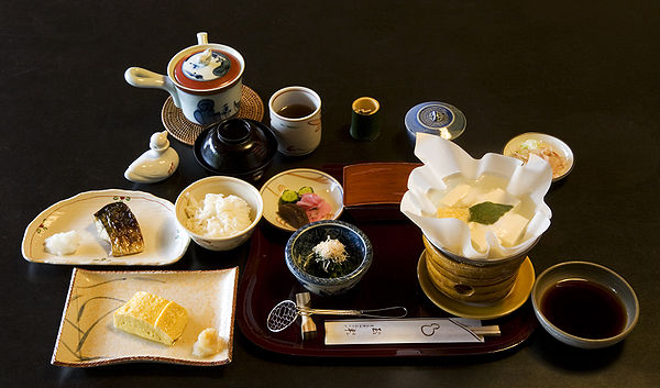 Breakfast at a ryokan (Japanese inn), featuring grilled mackerel, Kansai-style dashimaki egg, tofu in kaminabe (paper pot)