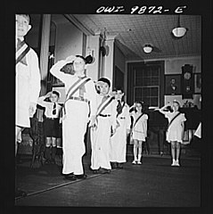 Color guard saluting the flag during a Columbus Day assembly