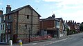 English: Some development work going on to a property at the end of Terminus Road, Cowes, Isle of Wight, where it meets Park Road (park road can be seen continuing up the hill). To the left (by the bollards) is Granville Road. This is by the Park Gates bus stop, and I always though the shetler that can be seen was at one point for the bus stop, but it had all been fenced off when seen here.