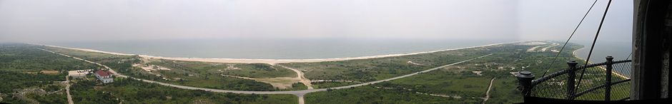 This image taken from the top of the lighthouse facing south shows the entirety of Lighthouse Beach. The parking lot of Field 5 of Robert Moses State Park can be seen next to the beach on the far right and the community of Kismet can be just seen in the mist on the far left. FI Lighthouse pan.jpg