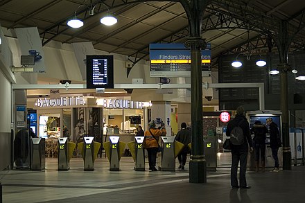 Ticket barriers at eastern entrance, retail stores in the background