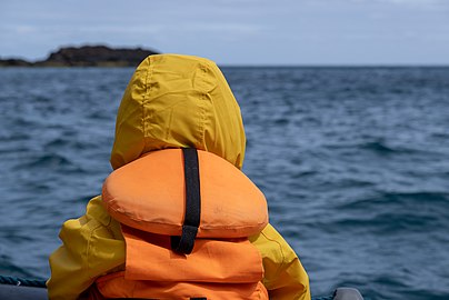 Gabriel on a boat near the southern cliffs of Santa Maria, Azores, Portugal