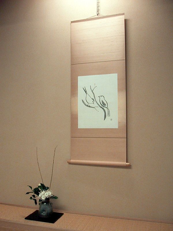 Ikebana flower arrangement in a tokonoma (alcove), in front of a kakemono (hanging scroll)