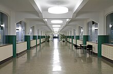 a long corridor with massive reinforced concrete beams on heavy supports