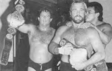 Steve Keirn (left) and Mike Graham (right) with the NWA Florida Tag Team Championships on August 21,1987. Keirn Graham Floria Tag Championship 1987.png