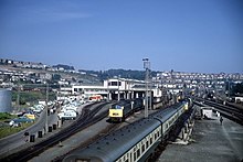 A view from the south in 1972. The carriages are standing where fuel oil was piped from wagons into the storage tanks. A 'Westerns' stand outside the long servicing shed. The main maintenance shed is the taller building behind. Laira Depot Plymouth. - geograph.org.uk - 818770.jpg