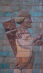 Terra-cotta frieze of the Apadana of Susa, depicting an Achaemenid soldier. Note the intricate clothing details, and lively coloration of the piece