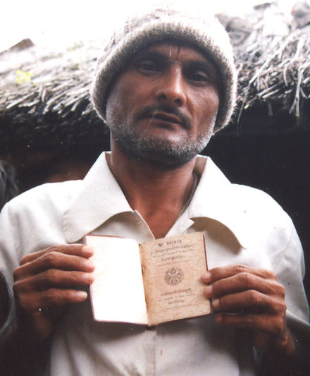 A Lhotshampa man holding his Bhutanese Citizenship Identity Card