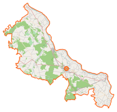 Mapa konturowa powiatu kozienickiego, w centrum znajduje się punkt z opisem „Elektrownia Kozienice”