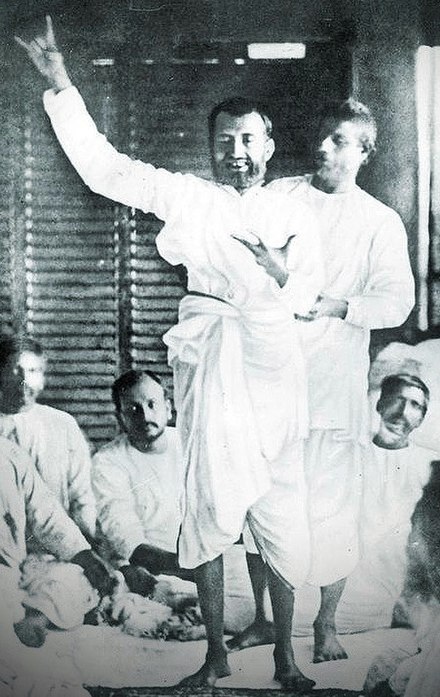 Ramakrishna in bhava samadhi after singing about Kali. His nephew Hriday, supporting him started uttering Om in his ear, bringing him back to normal consciousness. With Brahmo Samaj devotees at the house of Keshab Chandra Sen, 21 September 1879.