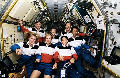 STS-47 crew pose for a portrait inside the Spacelab-J module during the mission.