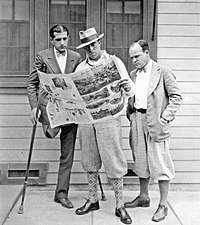 Raoul Walsh lee el periódico con el guionista Laurence Stallings (27 de octubre de 1918), al que tuvieron que amputar una pierna al ser herido en la I Guerra Mundial