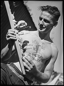 Sailor with a Popeye tattoo (1940) Tattooed man with bird, W. Silk of Paddington, Sydney, 24 April 1940 - Flickr - State Library of New South Wales collection.jpg