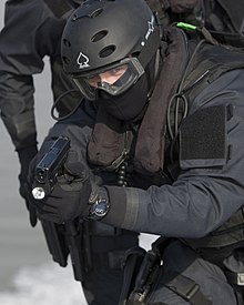 A firearms officer of the Metropolitan Police with a Glock pistol. Thames River Police Boarding Teams in Olympics Security Exercise, London MOD 45153772.jpg