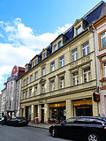 Residential building with a shop area in closed development