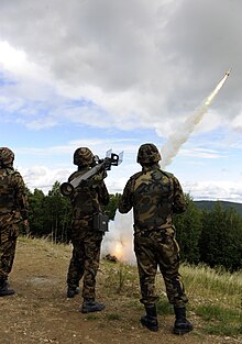 A Japan Air Self-Defense Force (JASDF) team looks on after the Type 91 Kai MANPAD fires a rocket at a mock airborne target. Type 91 SAM fire.JPG