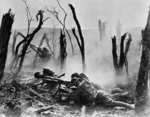 American infantry forces in 1918, firing a 37 mm. gun, advance against German positions in World War I.