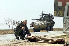 U.S. Navy Hospital Corpsman providing treatment to a wounded Iraqi soldier, 2003. US Navy 030402-M-3138H-006 Hospital Corpsman 3rd Class Christopher Pavicek from Escondido, Calif., provides aid to a wounded Iraqi soldier.jpg