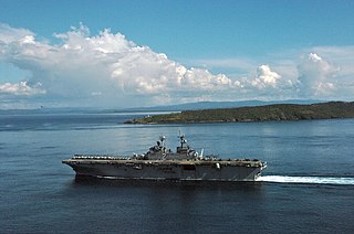 US Navy 061104-N-5067K-055 USS Essex (LHD 2) passes the Capul Island Lighthouse as it transits through the San Bernardino Straits.jpg