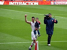 Van Persie holding his toddler son, Shaqueel, in 2010