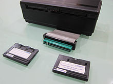 Rotronics Wafadrive shown with two Wafa tapes, a blank 64 kB and software release tape Wafadrive.jpg