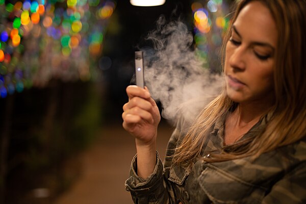 A person using a Juul device