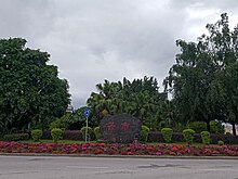 A stone with 芒市 script on the north entry roundabout of the city