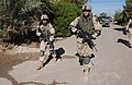 US infantry on patrol in Iraq, the soldier on left is using a M16 and the soldier on the right is using a M4