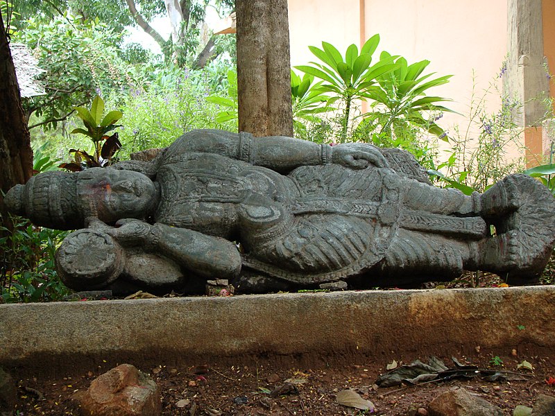 File:A stone sculpture of god Vishnu in reclining posture on display in Janapada Loka (Folk art museum).jpg