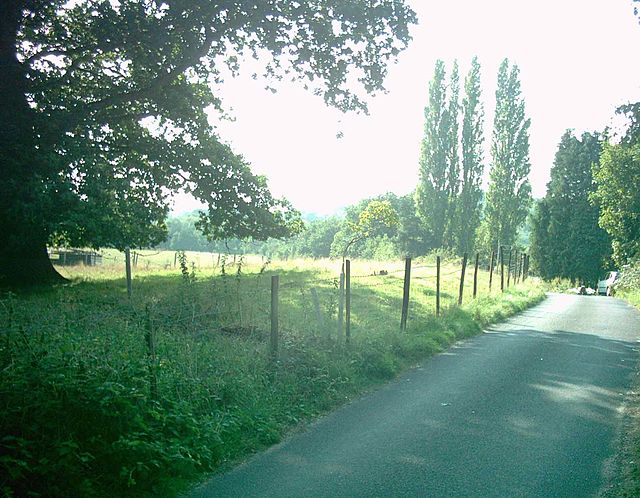 The barrow at Addington, bisected by a small road.
